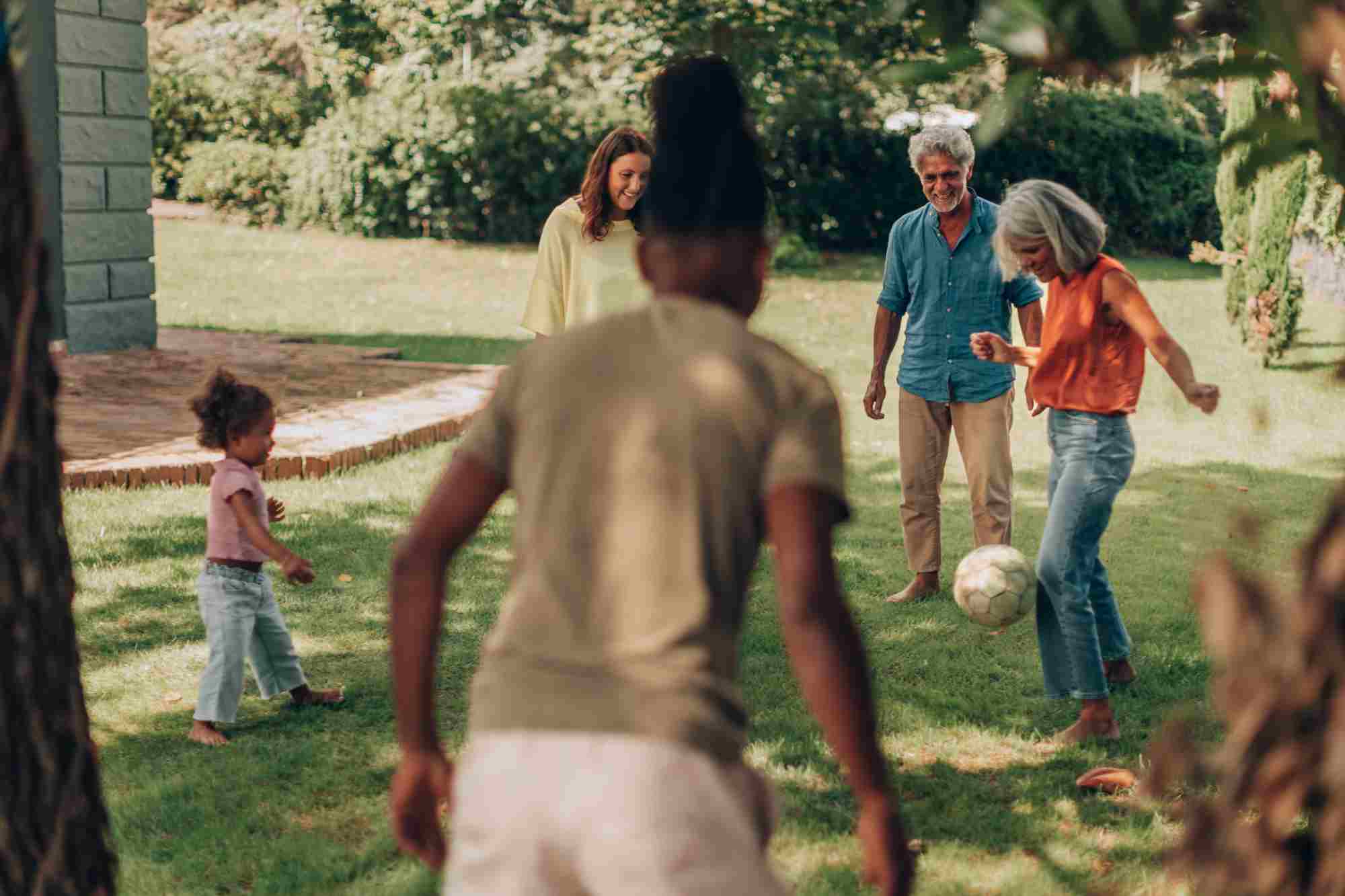 happy multi ethnic family play outside together