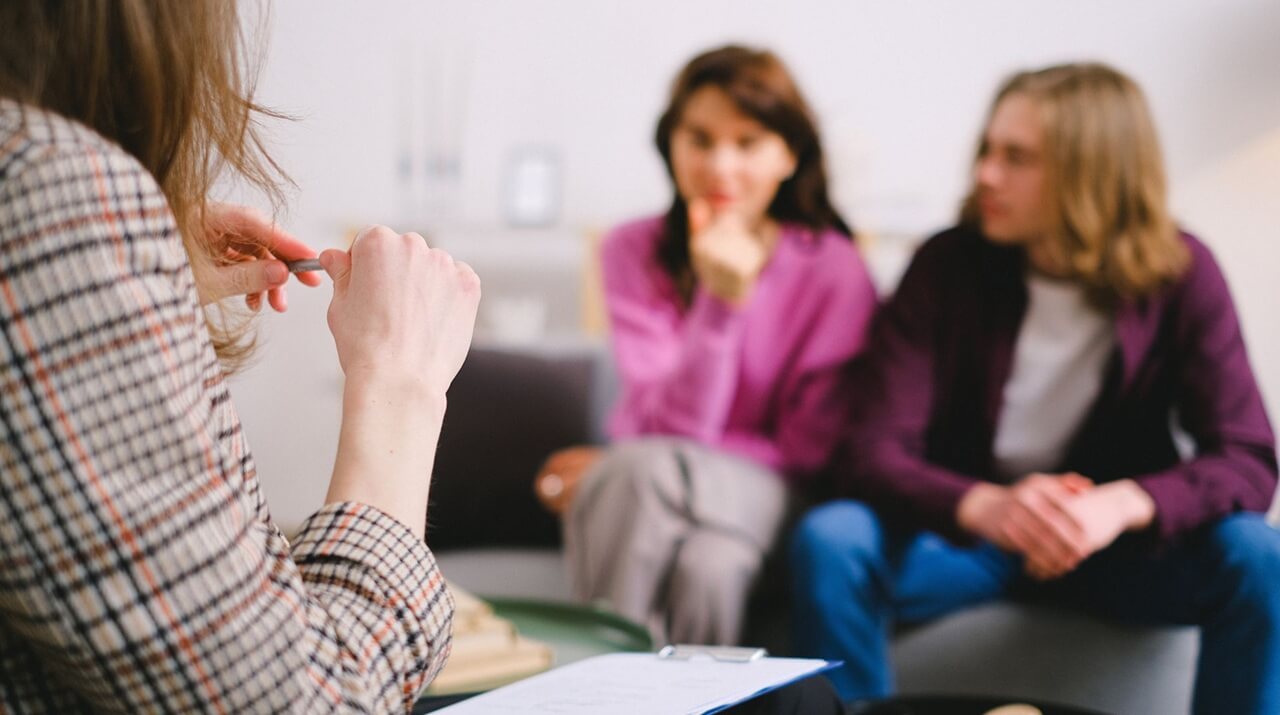 couple in therapy, guided by a professional therapist in a calm setting