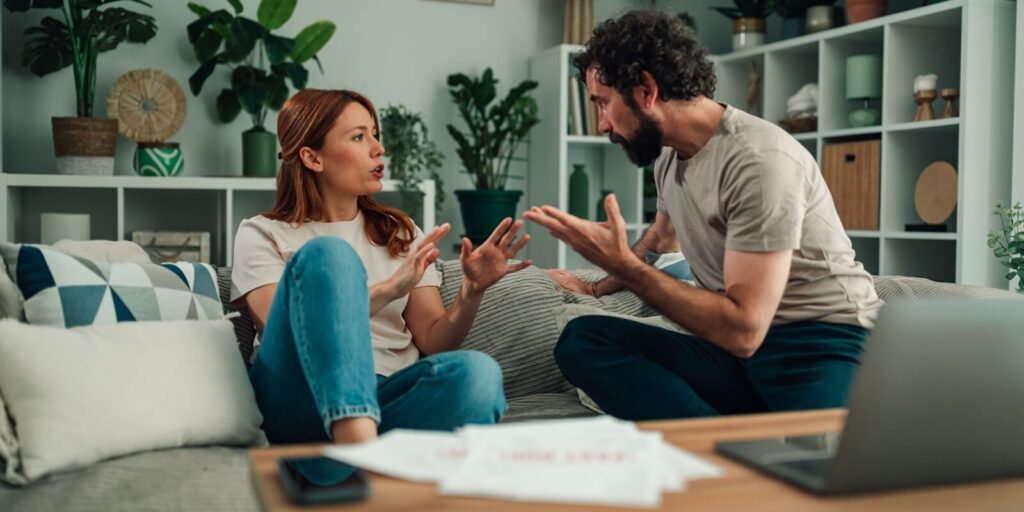 couple having conflict about relationship problems and financial stress at home, arguing and yelling