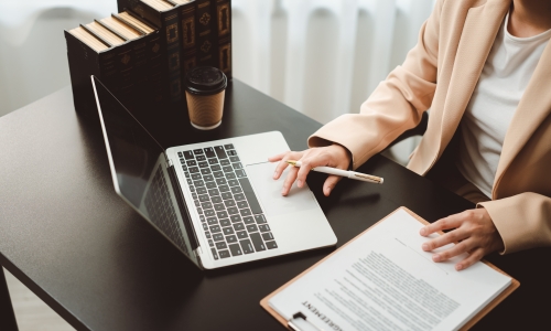 Family law attorney typing on a laptop at her desk