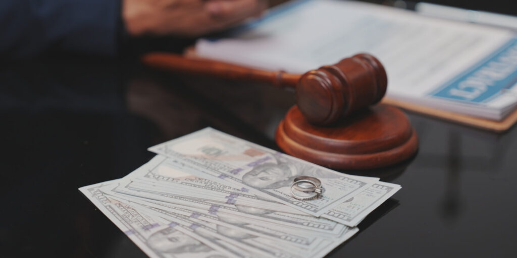 selective-focus close-up shot of a wooden judge's gavel being struck down onto its sound block